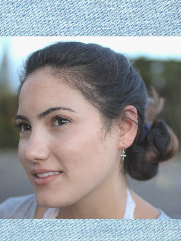 silver cross earrings on model with messy bun